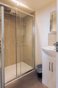 a bathroom with a shower and a sink at James Reckitt Library Serviced Apartments - Hull Serviced Apartments HSA in Hull
