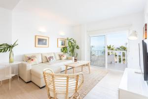 a living room with a couch and a table at Higuerón Rental Marítimo Romar C - Managed by Higuerón Resort in Fuengirola