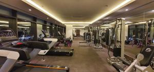 a gym with a bunch of treadms and machines at Porto Said Resort & Spa in Port Said