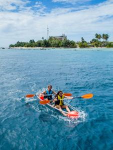 two people are in a kayak in the water at Season Paradise in Thulusdhoo