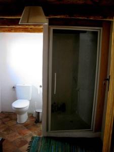a bathroom with a glass shower and a toilet at Abella Climb Eco Refugio Permanent Closure in Abella de la Conca