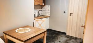 a small kitchen with a wooden table in a room at Willa Sowia Dolina in Karpacz +15 photos
