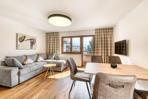 sala de estar con sofá y mesa en Alpenblick Apartments Montafon by A-Appartments en Schruns-Tschagguns