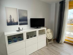 a white cabinet with a television on top of it at Apartamento nuevo, accesible y con piscina !!! in Salamanca