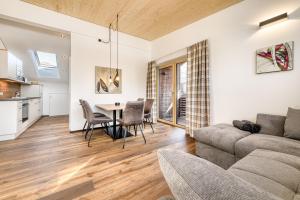 a living room with a couch and a table at Alpenblick Apartments Montafon by A-Appartments in Schruns +53 photos