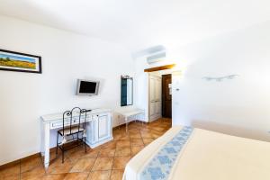 Postel nebo postele na pokoji v ubytování Hotel Costa Caddu