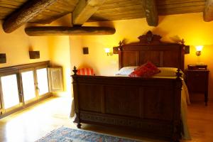 a bedroom with a large wooden bed in a room at Hotel La Val in Jarque de la Val