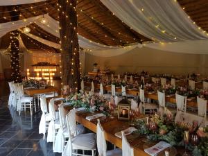 a large banquet hall with tables and white chairs at Letaba River Lodge in Tzaneen