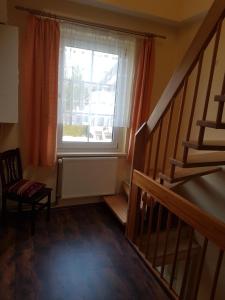 a room with a staircase and a large window at Über den Dächern von Ahlbeck in Ahlbeck +1 photo