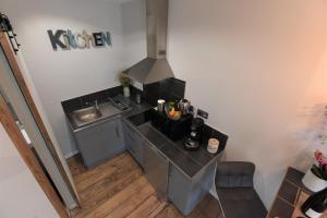 a small kitchen with a sink and a stove at BNB EPERNAY Studio 86 in Épernay