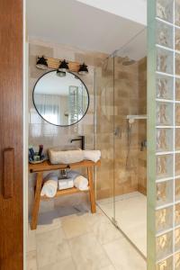 a bathroom with a sink and a shower at Playa Vista Mar Duplex in Port de la Selva