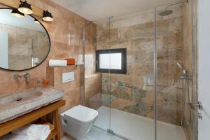 a bathroom with a shower and a toilet and a sink at Playa Vista Mar Duplex in Port de la Selva