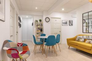 a living room with a table and chairs and a couch at Cruces Metro Rooms in Barakaldo