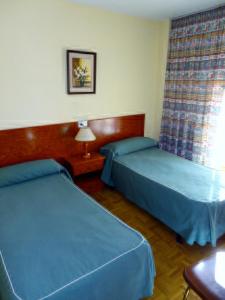 Кровать или кровати в номере Hotel Can-Vic