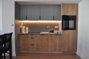 a kitchen with a sink and a microwave at WROCLOVE_NET APARTMENTS in Wrocław