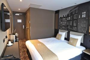 ein Schlafzimmer mit einem großen weißen Bett in einem Zimmer in der Unterkunft XO Hotels Infinity in Amsterdam