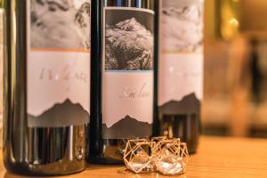 three bottles of wine sitting on top of a table at Appartement Wildspitz' in Vent