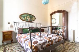 a bedroom with a bed and a mirror at Casa Betta e Elisa in Valderice