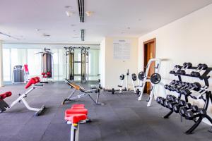 a gym with treadmills and machines in a room at SHH - Amazing Studio in Hercules Tower, Wadi Al Safa in Dubai
