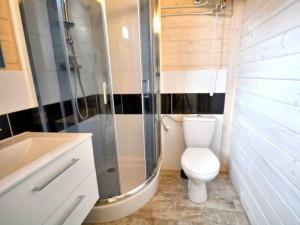 a bathroom with a toilet and a shower and a sink at Domki Kaja in Rewal +14 photos