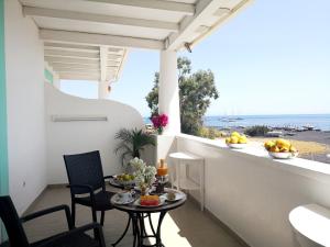 a balcony with a table and chairs and a view of the ocean at Hotel Ossidiana Stromboli Center in Stromboli