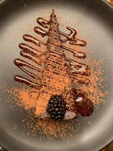 a dessert with a tower on a plate with chocolate at Sugar Hill Inn in Sugar Hill