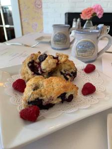 a plate of muffins and berries on a table at Sugar Hill Inn in Sugar Hill