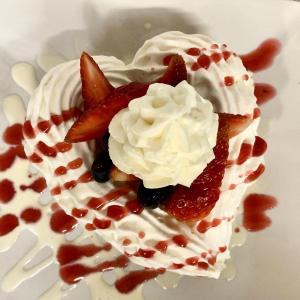 a dessert with strawberries and whipped cream on a plate at Sugar Hill Inn in Sugar Hill