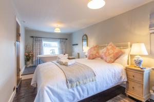 a bedroom with a bed with a teddy bear on it at Turford House, Ludlow in Ludlow