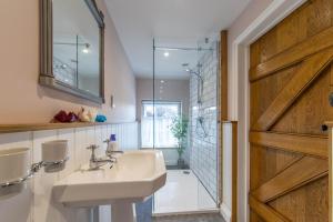 a bathroom with a sink and a shower and a sliding door at Turford House, Ludlow in Ludlow +32 photos