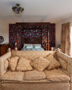 a couch sitting in front of a bed at The Dales in Gorey