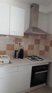 a kitchen with a stove top oven in a kitchen at Gite Les Oliviers in Sablet