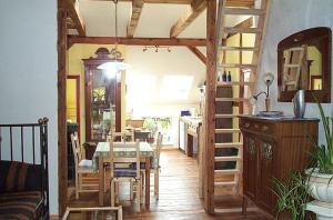 a kitchen and dining room with a table and a ladder at Anno-Nostalgia in Rheinsberg