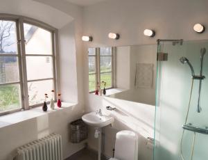 a bathroom with a shower and a sink and a mirror at Biskops Arnö in Biskops Arnö +11 photos