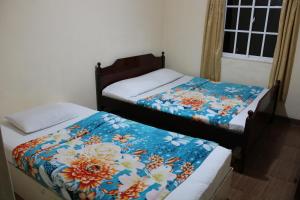 Tempat tidur dalam kamar di Blossomwell Bungalow