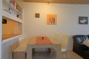 a small dining room with a table and chairs at Apartment 527 in Hohegeiß