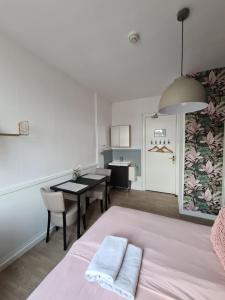 a bedroom with a bed and a table and chairs at Pension Corper in Zandvoort