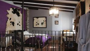 a bedroom with a crib and purple walls at El Rincón de San José in Marjaliza