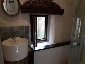 a bathroom with a sink and a window at Countryside tiny house near Chateau de Hautefort in Boisseuilh