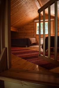 a attic room with a bed and a window at Puruvesi Holiday Villas, Riuttahovi in Hiukkajoki