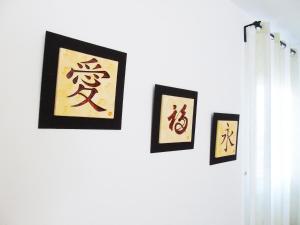a group of four pictures hanging on a wall at Fleitas Penthouse with terrace in San Andrés