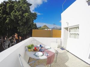 a white table and chairs on a balcony at Fleitas Penthouse with terrace in San Andrés