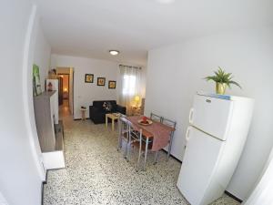 a kitchen and living room with a refrigerator and a table at Fleitas Penthouse with terrace in San Andrés