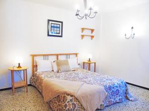 a bedroom with a bed and two side tables at Fleitas Penthouse with terrace in San Andrés