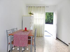 a dining room with a table and chairs and a refrigerator at Fleitas Penthouse with terrace in San Andrés