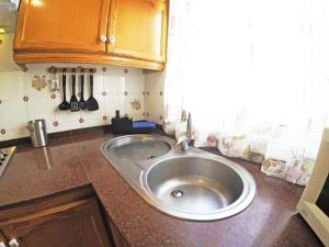 a kitchen with a large silver sink in a kitchen at Fleitas Penthouse with terrace in San Andrés +30 photos