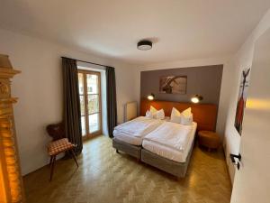 a hotel room with a bed and a window at Freihaus18**** in Bad Wiessee