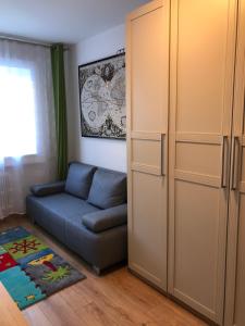 a living room with a couch and a closet at Apartment HUGO in Bad Kleinkirchheim