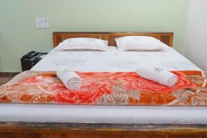 a bed with two pillows on top of it at Viraz Valley in Gokarna