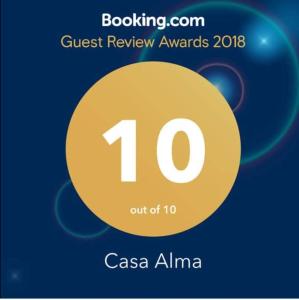a sign that reads quest review awards with a yellow circle at Casa Alma in Marbella